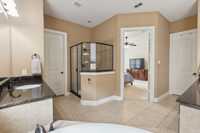 ensuite bathroom with baseboards, visible vents, and a stall shower