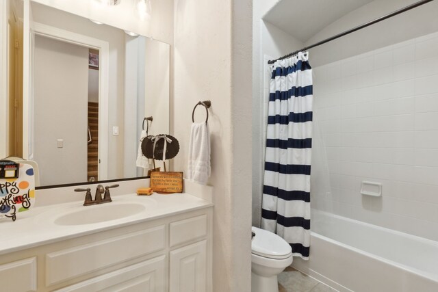 bathroom with vanity, tile patterned flooring, toilet, and shower / tub combo
