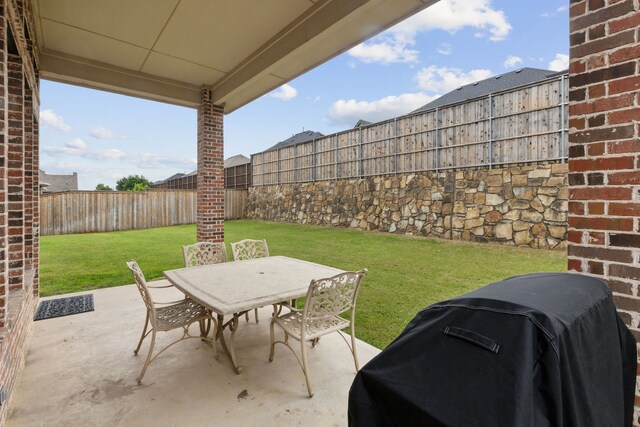 view of patio / terrace with a fenced backyard, outdoor dining area, and area for grilling