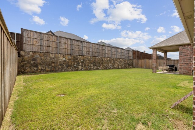 view of yard with a patio and a fenced backyard