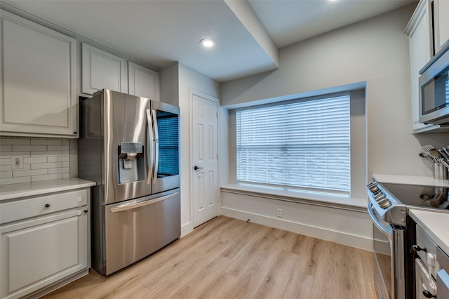 8909 White Pine Ln, Dallas, TX 75238 - kitchen featuring appliances with stainless steel finishes, light wood-style floors, light countertops, backsplash, and recessed lighting