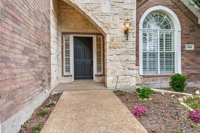 8909 White Pine Ln, Dallas, TX 75238 - view of exterior entry with stone siding and brick siding