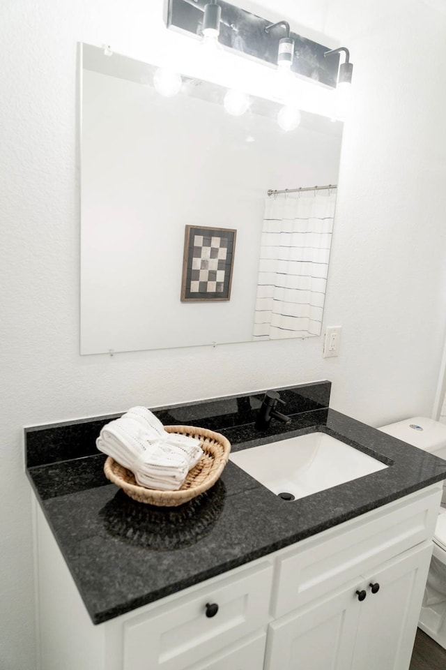 full bathroom featuring toilet and vanity