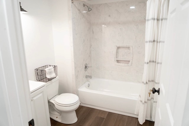 full bath featuring vanity, toilet, wood finished floors, and shower / tub combo