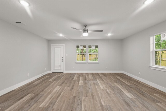 spare room with recessed lighting and plenty of natural light