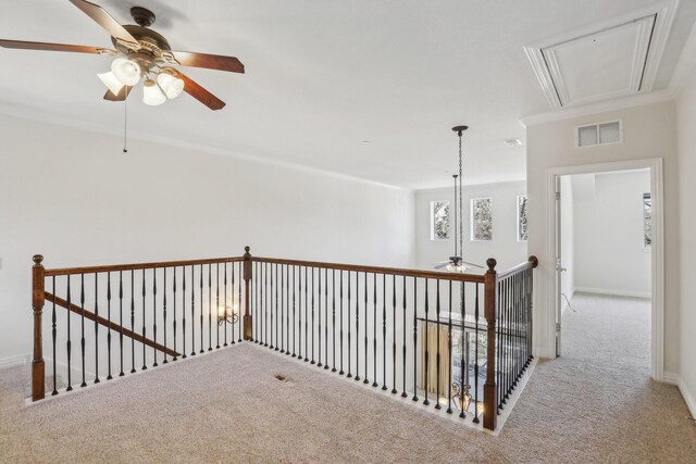 hallway featuring visible vents, baseboards, attic access, carpet, and an upstairs landing