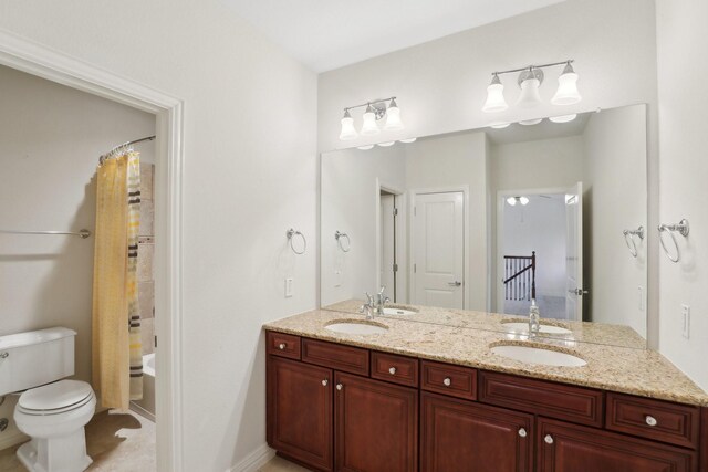 full bath with double vanity, a sink, shower / tub combo, and toilet