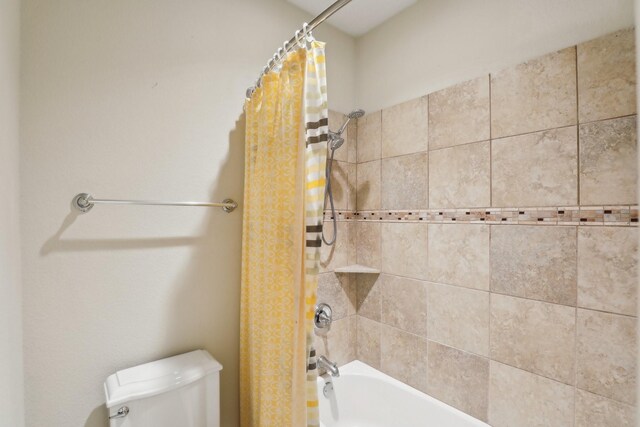 full bathroom with toilet and shower / bath combination with curtain