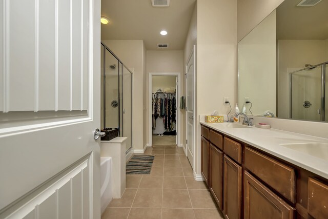full bath featuring tile patterned floors, a sink, and a stall shower