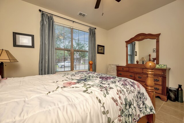 tiled bedroom with ceiling fan and visible vents