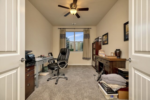 office space featuring carpet floors, a ceiling fan, and baseboards