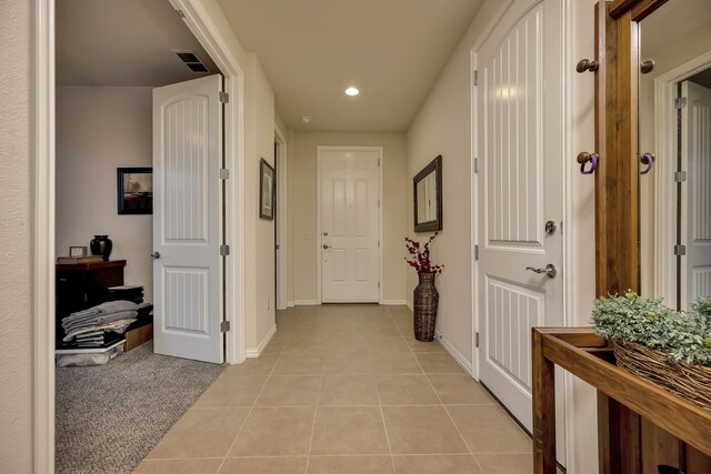 hall featuring recessed lighting, baseboards, light tile patterned floors, and visible vents