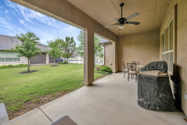 view of patio / terrace with fence and a ceiling fan