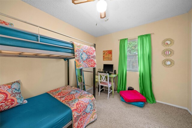 bedroom with ceiling fan, baseboards, and carpet