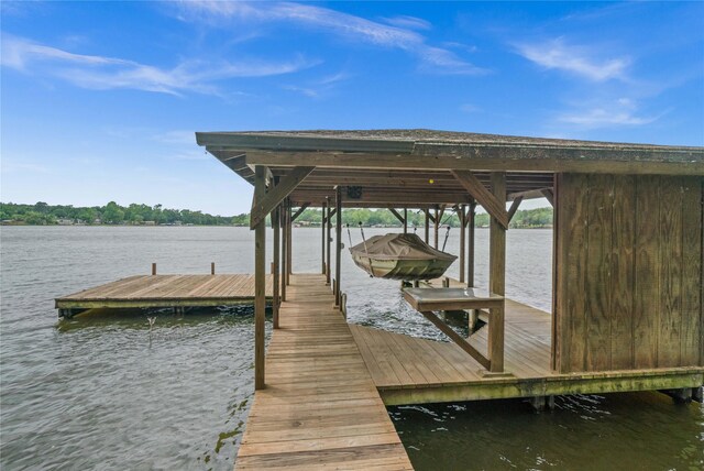 dock area with a water view and boat lift