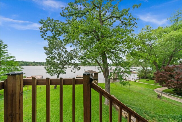 view of yard with a water view and fence