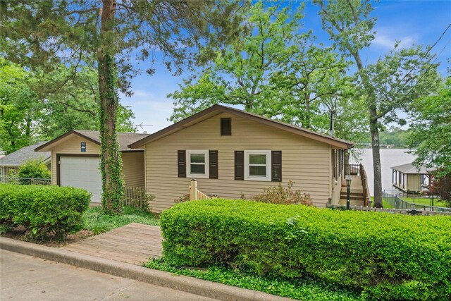 view of front of property with fence and a garage
