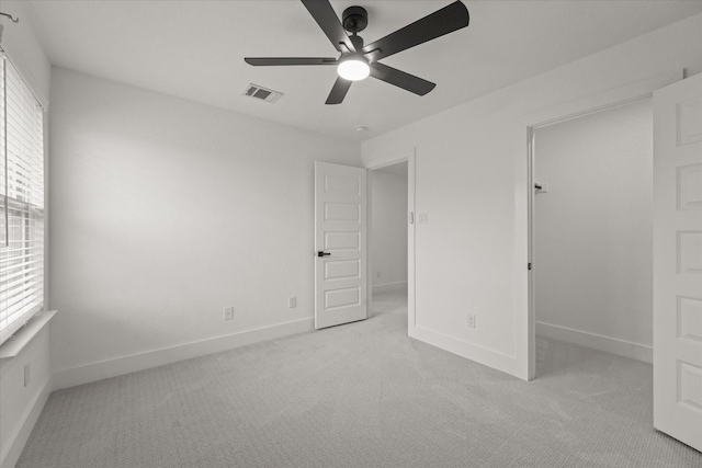 3805 Bluestem Blvd, Denton, TX 76226 - unfurnished bedroom with light colored carpet, ceiling fan, and a walk in closet