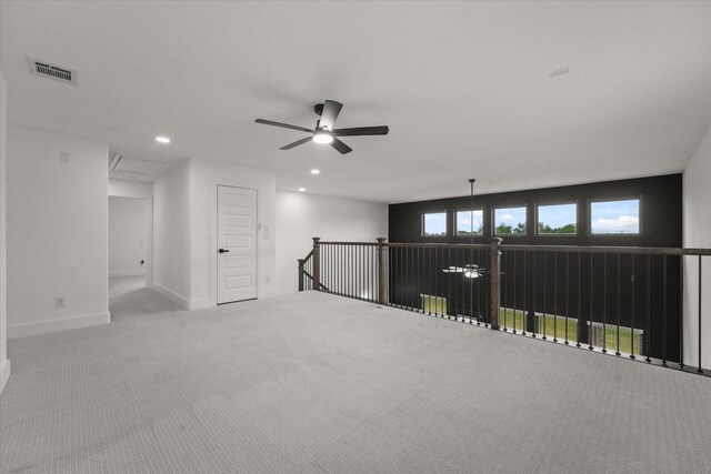 carpeted empty room with attic access, a ceiling fan, baseboards, recessed lighting, and visible vents