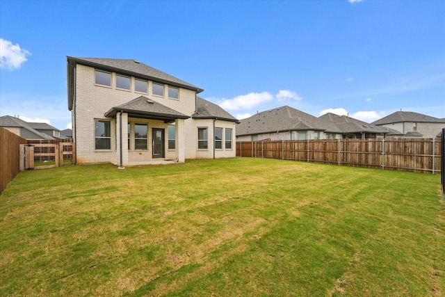 3805 Bluestem Blvd, Denton, TX 76226 - back of property featuring a fenced backyard, brick siding, and a patio area