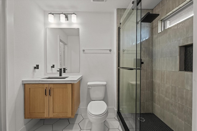 full bathroom featuring tile patterned flooring, a stall shower, toilet, and vanity