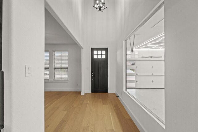 foyer featuring baseboards and wood finished floors