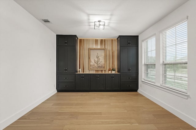 3805 Bluestem Blvd, Denton, TX 76226 - unfurnished dining area featuring baseboards and light wood-style flooring