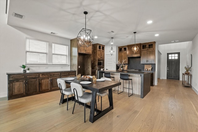 3805 Bluestem Blvd, Denton, TX 76226 - dining space with light wood finished floors, recessed lighting, and a chandelier