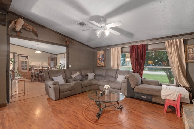 living area featuring crown molding, ceiling fan, wood finished floors, and lofted ceiling