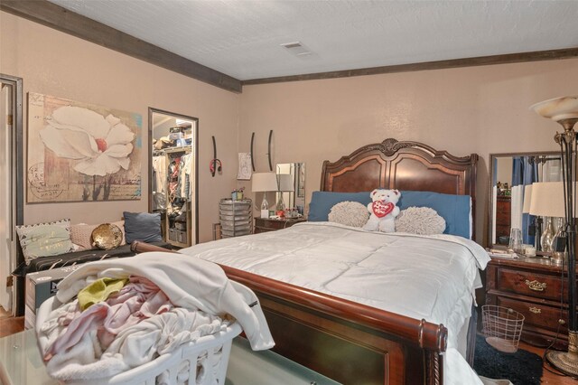 bedroom with a spacious closet, a closet, and visible vents