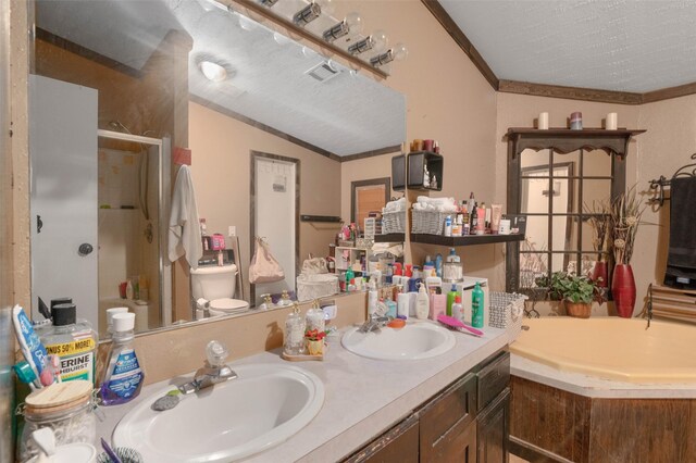 full bath featuring double vanity, a sink, ornamental molding, and a shower stall