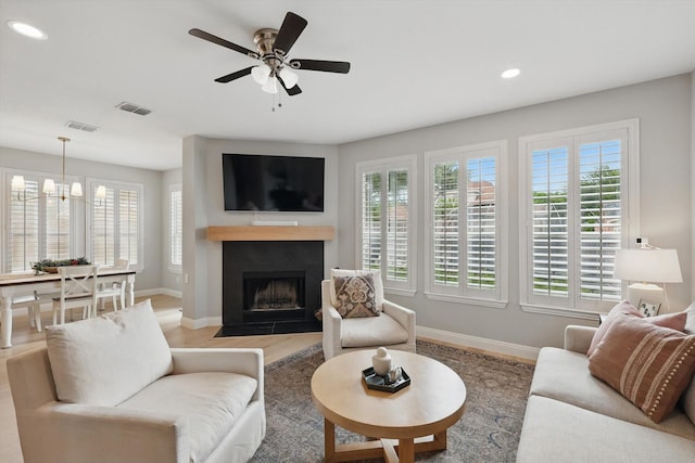 living area featuring visible vents, baseboards, and a healthy amount of sunlight