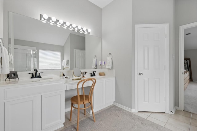 full bathroom with double vanity, a sink, tile patterned floors, and a shower stall
