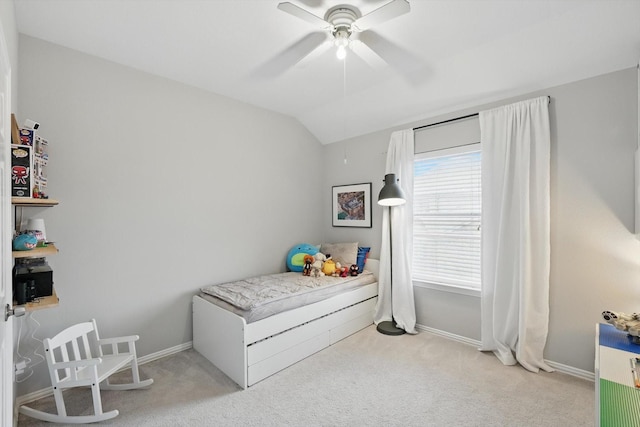 carpeted bedroom featuring a ceiling fan, baseboards, and lofted ceiling