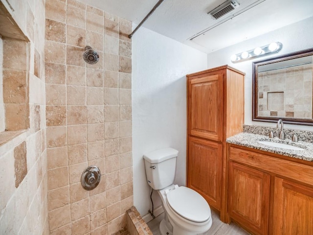 3817 Rawlins St Unit 103, Dallas, TX 75219 - full bathroom with tiled shower, toilet, and vanity