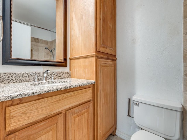 3817 Rawlins St Unit 103, Dallas, TX 75219 - bathroom featuring toilet, vanity, and a shower
