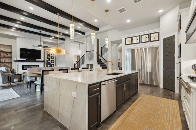 13420 Tim Tam Cir, Frisco, TX 75035 - kitchen with ceiling fan, a spacious island, a sink, open floor plan, and stainless steel appliances