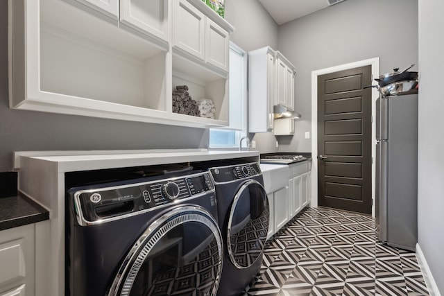 13420 Tim Tam Cir, Frisco, TX 75035 - laundry area featuring separate washer and dryer, baseboards, and cabinet space