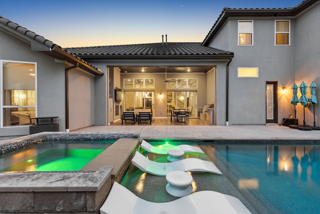 13420 Tim Tam Cir, Frisco, TX 75035 - rear view of house featuring a patio, an in ground hot tub, stucco siding, and a tile roof