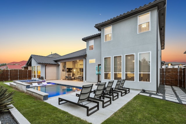 13420 Tim Tam Cir, Frisco, TX 75035 - back of property at dusk featuring a fenced backyard, a patio, a yard, and a tile roof