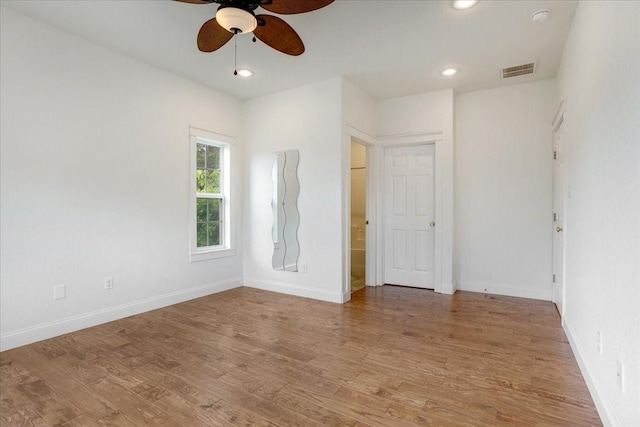 unfurnished bedroom with visible vents, baseboards, and wood finished floors