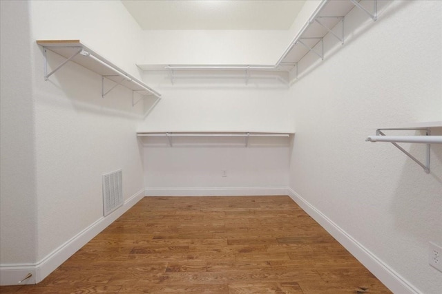 spacious closet with visible vents and wood finished floors