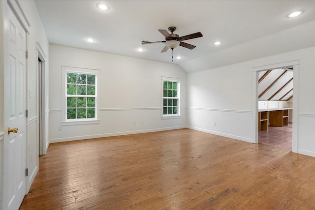 empty room with lofted ceiling, baseboards, ceiling fan, recessed lighting, and light wood-style flooring