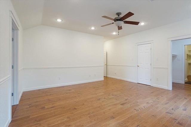 unfurnished bedroom with light wood-style floors, recessed lighting, a ceiling fan, and a spacious closet