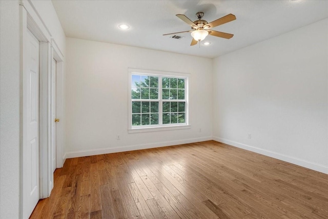 unfurnished bedroom featuring light wood-style flooring, a ceiling fan, baseboards, recessed lighting, and visible vents