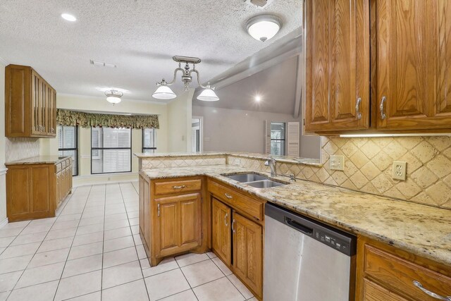 kitchen with a sink, light tile patterned floors, stainless steel dishwasher, and brown cabinetry