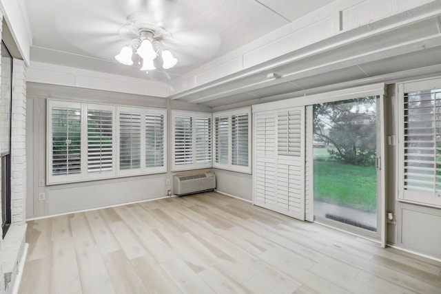 unfurnished sunroom featuring a wall mounted AC
