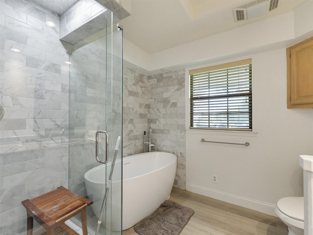 2802 Cinnamon Springs Rd, Glenn Heights, TX 75154 - full bathroom with a tile shower, baseboards, a freestanding tub, wood finished floors, and visible vents