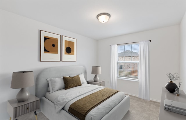 bedroom featuring baseboards and light colored carpet