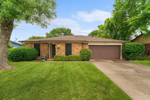 ranch-style home with a garage, concrete driveway, a front yard, and brick siding